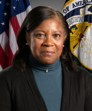 Image of Ms. Jessie Hill Roberson in front of American flag.
