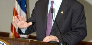 Image of a man standing behind a podium and speaking at the 2010 Victor Stello Junior award presentation